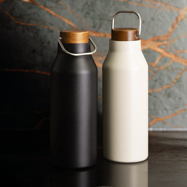 A drink bottle duo featuring a matte black and a creamy white vacuum-sealed design with wooden lids and metal handles.