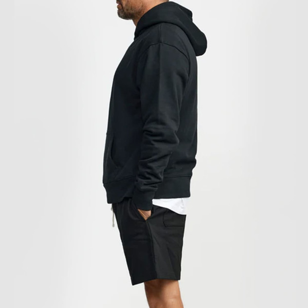 A black hoodie worn by a man, featuring a front pocket and a hood, paired with black shorts. A black hoodie worn by a man, featuring a front pocket and a hood, paired with black shorts.
