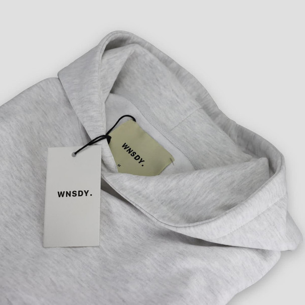 A grey hoodie with a hood and tags, featuring a logo on the tags. A grey hoodie with a hood and tags, featuring a logo on the tags.
