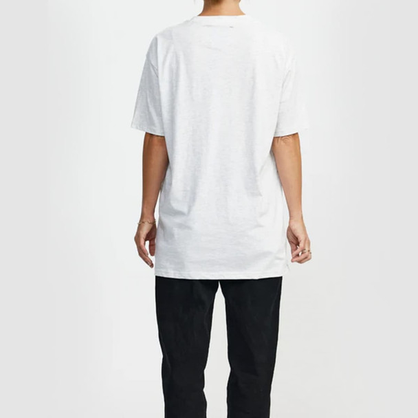 A white t-shirt with short sleeves is displayed on a person from the back, paired with black trousers. The shirt features a logo. A white t-shirt with short sleeves is displayed on a person from the back, paired with black trousers. The shirt features a logo.