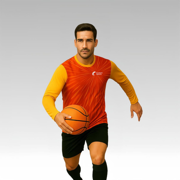 A model wearing a long-sleeved shirt featuring a red and yellow design, holding a basketball. The shirt has a logo.