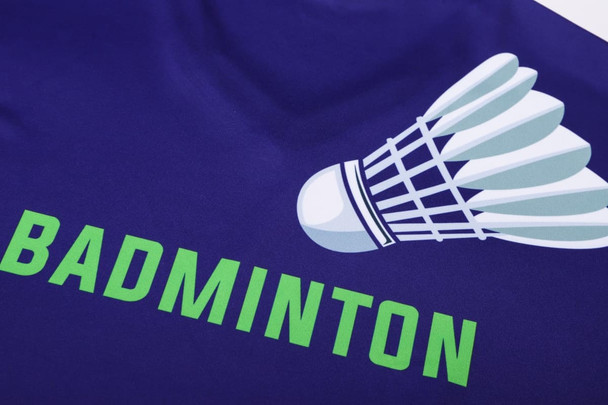A purple long-sleeve V-neck shirt featuring a badminton shuttlecock design and the word "BADMINTON" in green.