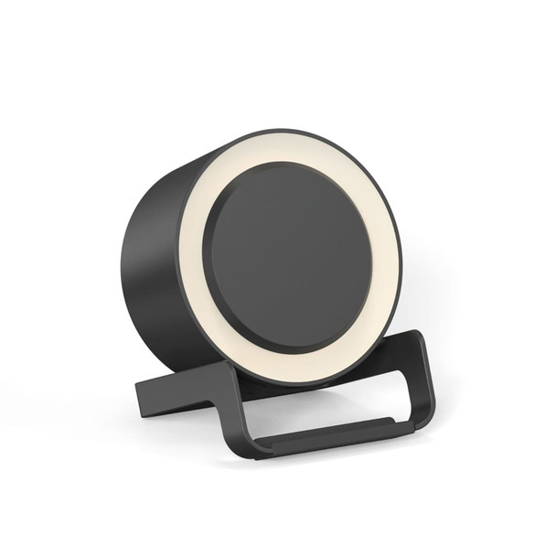 A round black night light speaker with a wireless charging stand. The product features a light ring around the top edge.