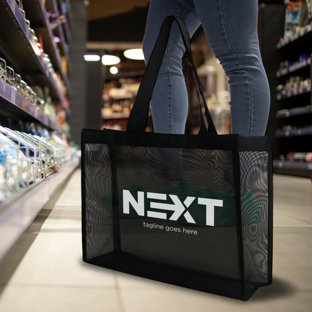 A black transparent mesh tote bag with a visible logo, placed in a shopping aisle.