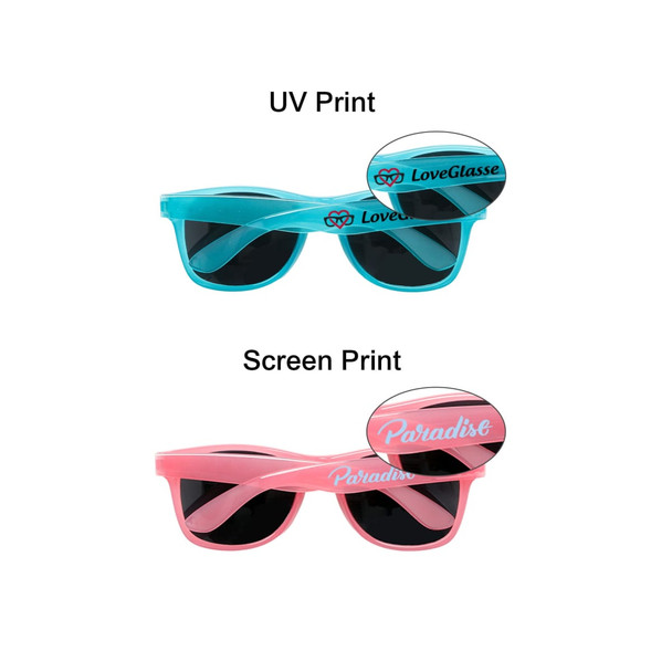 Glow in the dark sunglasses in blue and pink, featuring a logo on each pair and dark lenses.