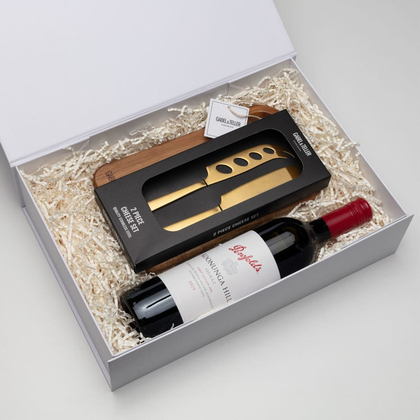 A drink bottle in a gift box featuring red wine and a wine opener, with a branded logo, surrounded by white filler. A drink bottle in a gift box featuring red wine and a wine opener, with a branded logo, surrounded by white filler.