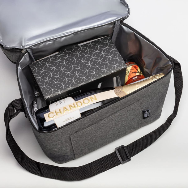 A grey insulated bag containing a bottle of Chandon, gourmet snacks, and a gift box. Features a branded logo.