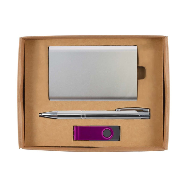 A silver cardholder, silver pen, and a purple USB drive arranged in a cardboard gift box.