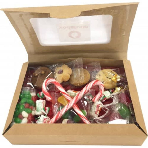 A kraft gift box filled with assorted candies, cookies, and decorative candy canes in red, green, and gold.