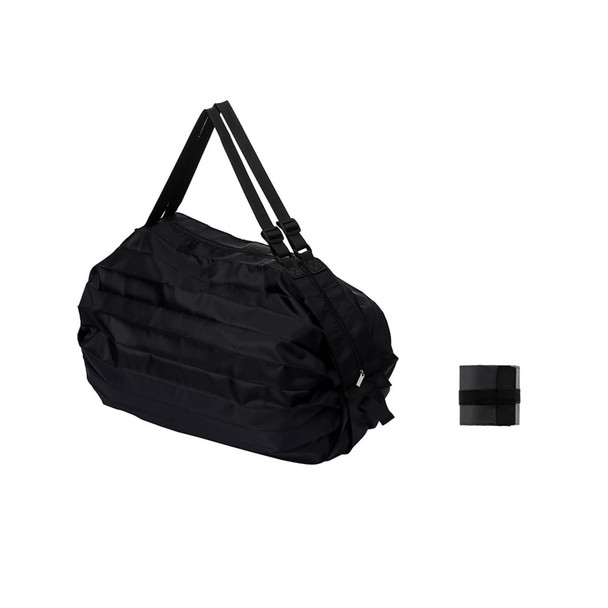 A foldable black shoulder bag with adjustable straps, shown alongside a compact folded version.