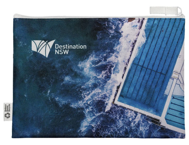 A blue and white conference bag featuring an aerial image of water and buildings, with a logo printed on it.