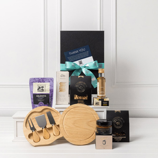 A gourmet entertainer set featuring wooden serving boards, cheese knives, gourmet treats, and a drink bottle, presented in a gift box.