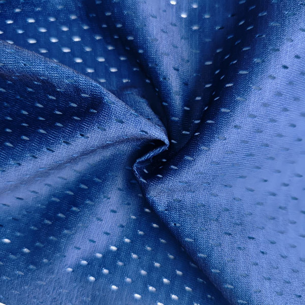 A close-up of a blue, perforated fabric, showcasing its texture and sheen. The material appears lightweight and smooth.