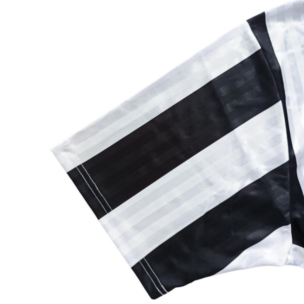 A loose-fitting unisex polo jersey in black and white stripes, made from 100% polyester, featuring a logo.