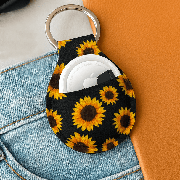 A neoprene keychain featuring a vibrant sunflower design, with a metallic keyring attached.