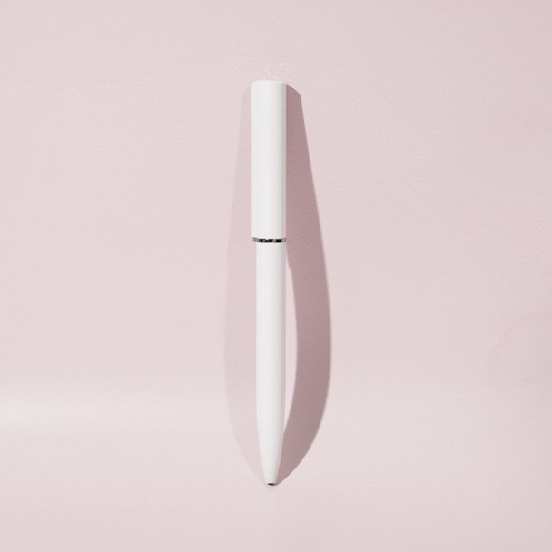 A white ballpoint pen with a sleek design and mirror finish, set against a soft pink background.
