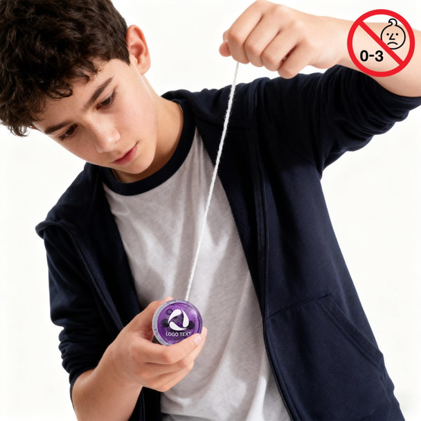 A boy is playing with a purple yoyo, pulling the string down as he focuses on his trick.