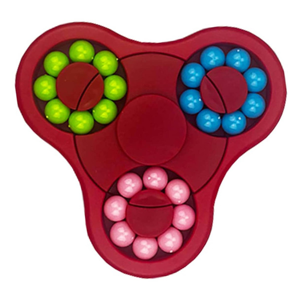 A red fidget spinner featuring blue, green, and pink balls in circular arrangements around a central hub.
