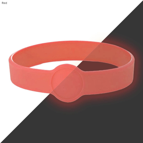A red silicone wristband with a circular feature at the centre, designed for custom design.