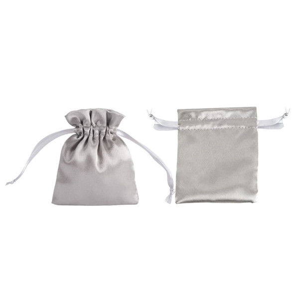 Two silver silk satin drawstring bags, one standing upright and the other lying flat, both featuring white drawstrings.