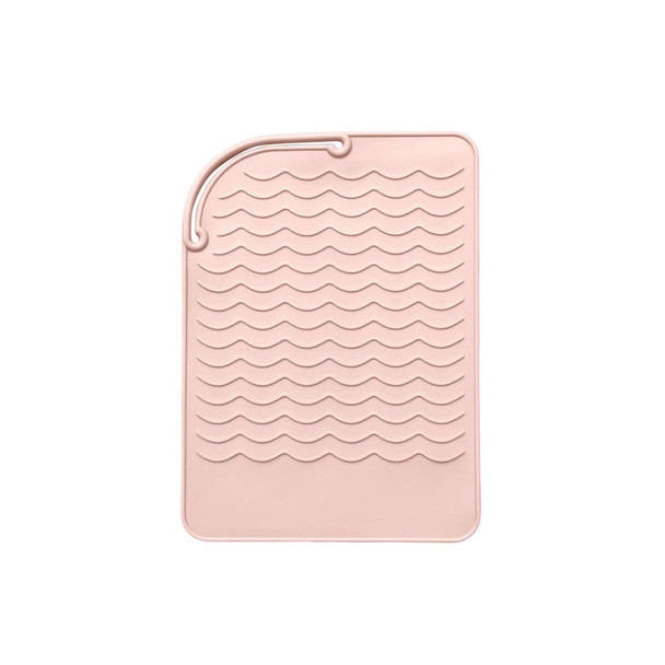 A pink silicone hair straightener pad with a textured wave design for heat protection and stability.