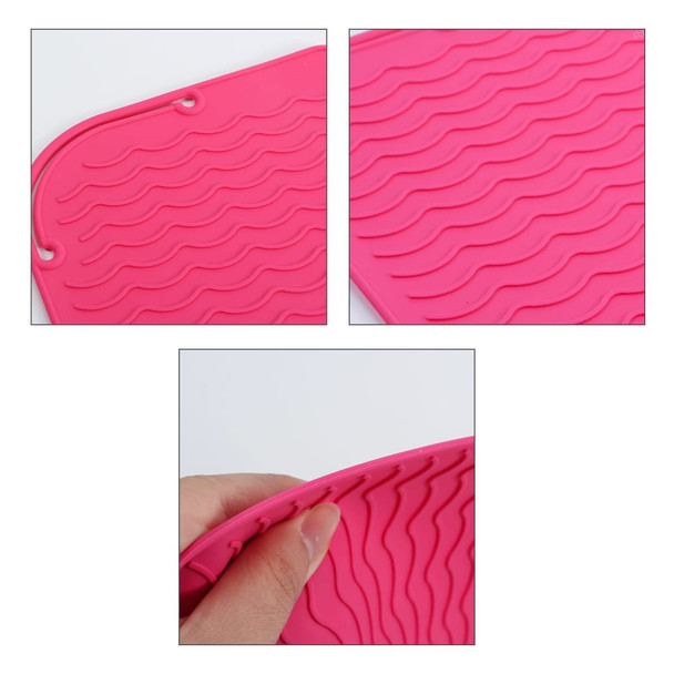 A pink silicone hair straightener pad with wave texture, featuring a hand holding one corner. It has a logo.
