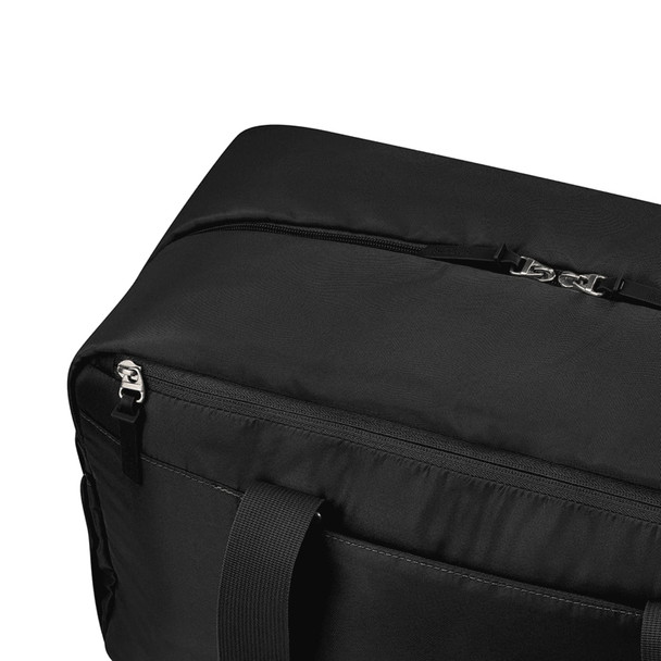A black duffle bag featuring a zip closure and sturdy handles, with a logo present on the design.