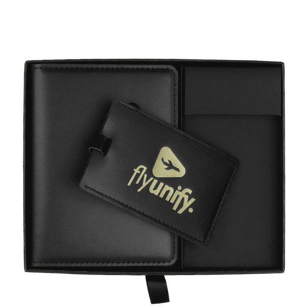A black gift box contains a black luggage tag and a cardholder with a logo.