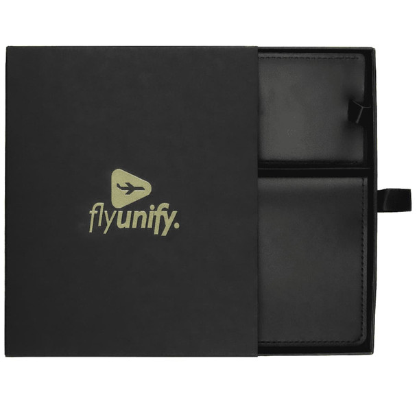 A black travel gift set featuring leather passport holder and luggage tag, presented in a sleek box with a logo.