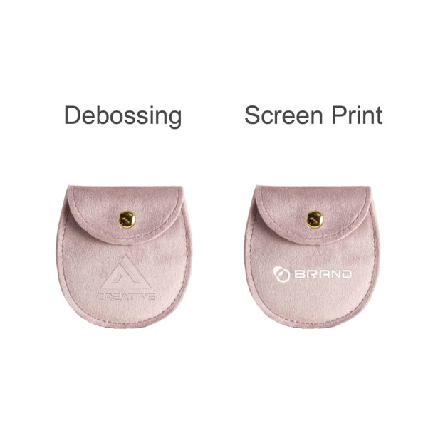 A pink oval velvet jewelry pouch with a button closure and branding options for debossing and screen printing.
