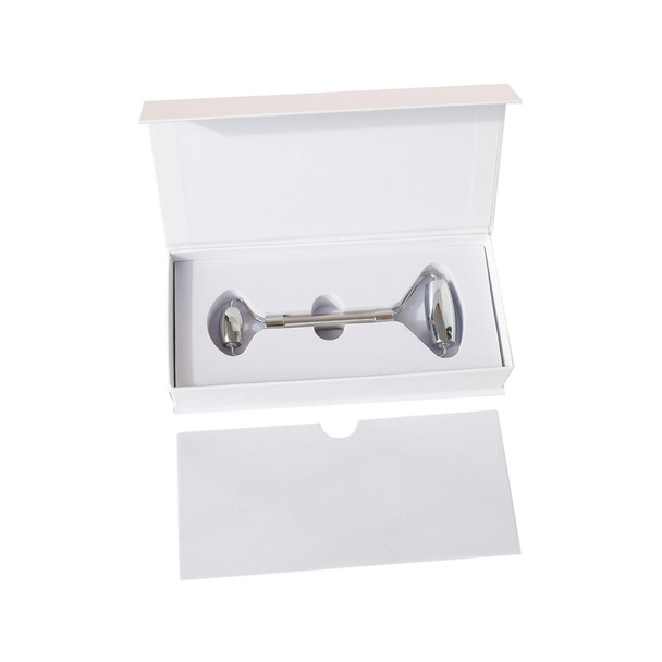 A stainless steel facial roller inside a white box with a removable lid. The box features a simple design.