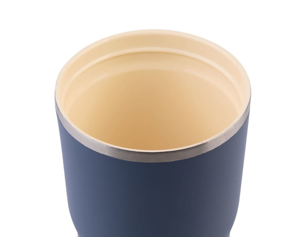 A drink bottle featuring a navy exterior and a cream interior, with a stainless steel rim and a logo.
