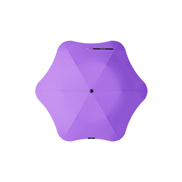 A purple BLUNT Metro Umbrella with a unique octagonal shape and a central button. The umbrella features a branding logo.