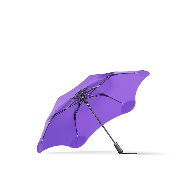 A purple BLUNT Metro Umbrella with a unique shape and a sturdy black frame. It features a logo on the handle.