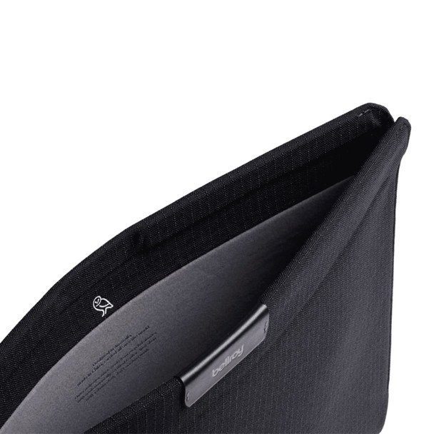 A black laptop sleeve with a soft interior lining and a logo. The opening reveals a sleek design.
