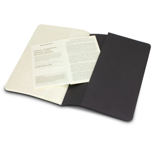 A Moleskine Cahier Journal, featuring a black cover with cream-coloured lined pages and additional inserts.