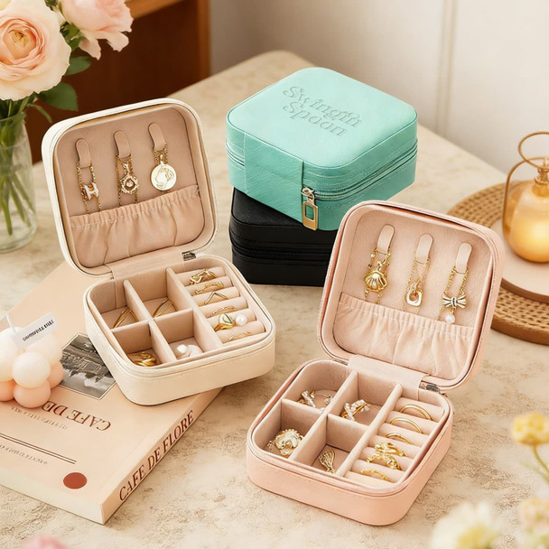 A set of PU leather jewellery boxes in mint green, black, cream, and pink, featuring various compartments for accessories.