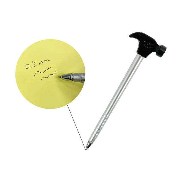 A hammer-shaped ballpoint pen in silver and black, with a writing sample on a yellow notepad.