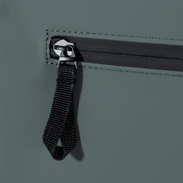 A close-up of the grey Resi Recycled Roll-Top 18L Backpack showing the zip and pull tab design.