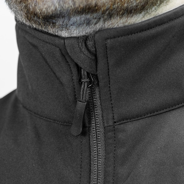 A close-up of a black soft shell jacket featuring a high collar and zip closure, with branding visible.