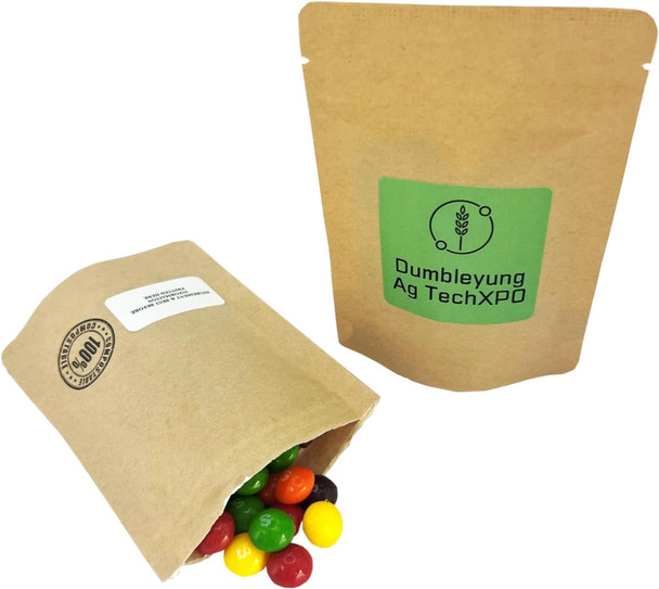 A compostable bag filled with colourful Skittles lollies, displayed alongside another similar bag.