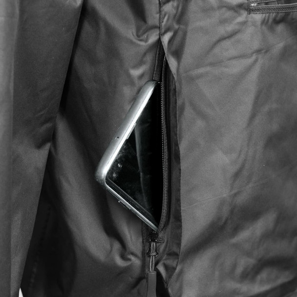 A close-up view of a black windbreaker jacket featuring a zippered pocket with a smartphone inside.