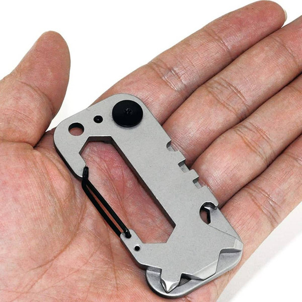 A compact, silver multi-tool held in a hand, featuring various tool functions and a keyring attachment.