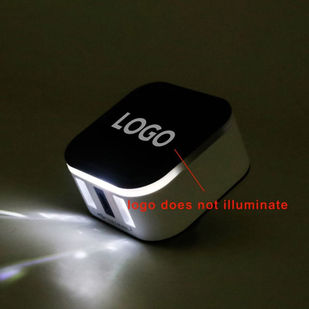 A travel adapter in black and white with two USB ports and a non-illuminating logo.