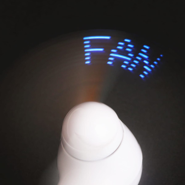 A white handheld fan displays blue LED text while in motion. Features a logo on the body.