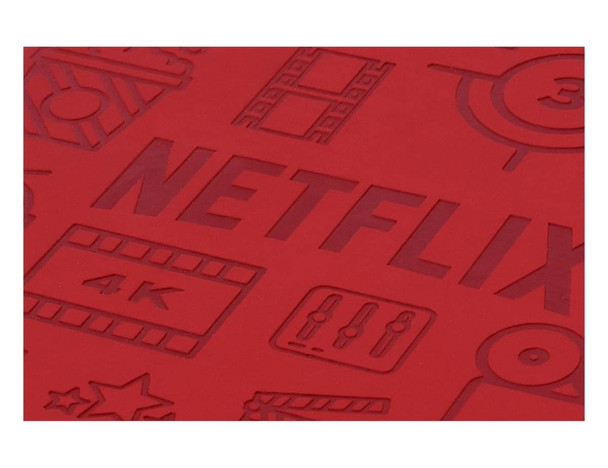 A red notebook cover features debossed design elements related to film and streaming. It includes a branding logo.