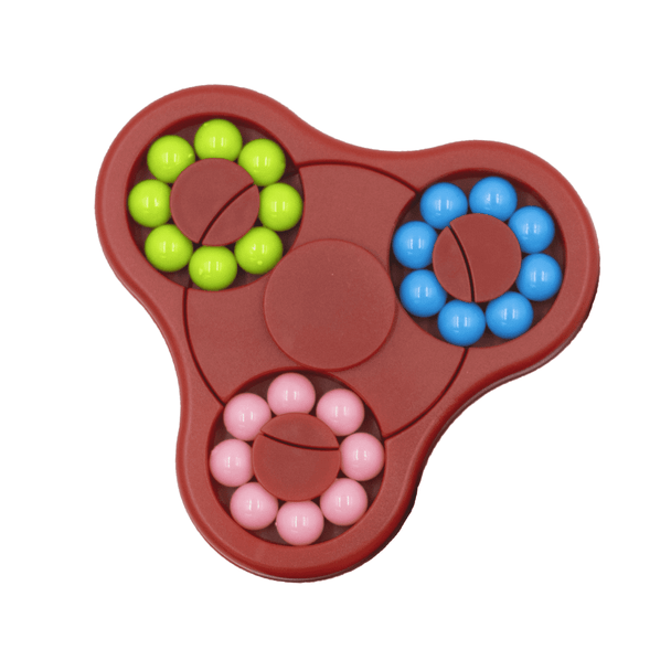 A red puzzle game with three sections, featuring pink, green, and blue balls arranged in circular patterns.