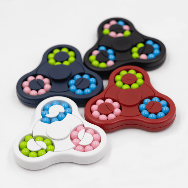 A set of four Spin Buddy Puzzle Games in red, white, black, and navy, featuring colourful beads in pink, green, and blue.