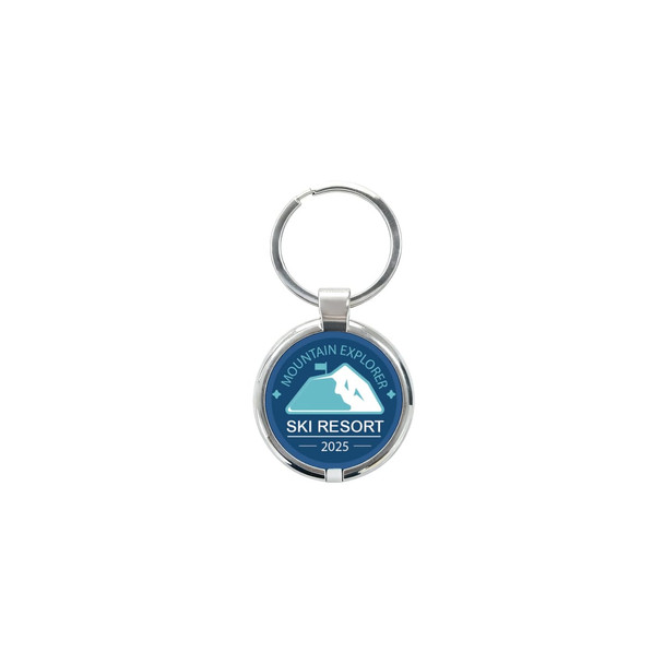 A round epoxy tag in blue and silver featuring a mountain graphic and a keyring attachment.
