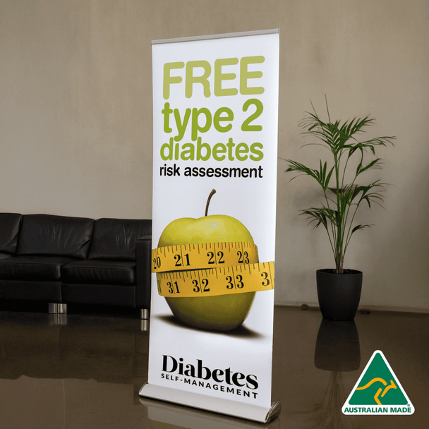 A roll-up banner featuring an apple and a measuring tape, predominantly white with green accents, and an Australian made logo.